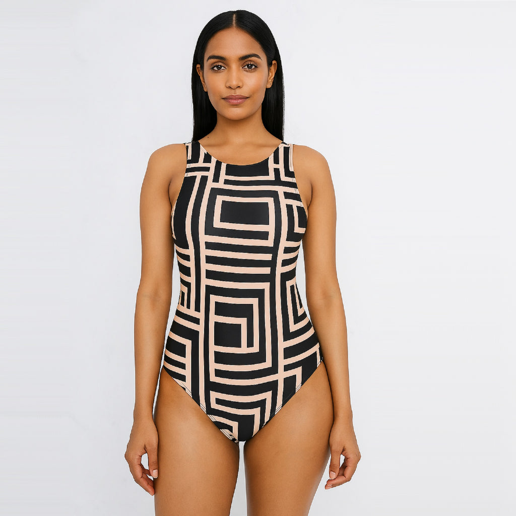 Woman wearing a geometric patterned one-piece swimsuit on a plain background - The Beach Company - Shop Swimwear Online in Mumbai