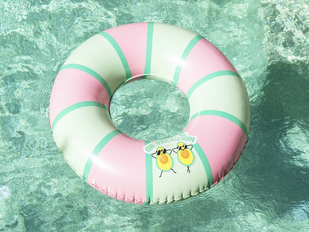 Pink and green inflatable ring with cartoon design in a pool