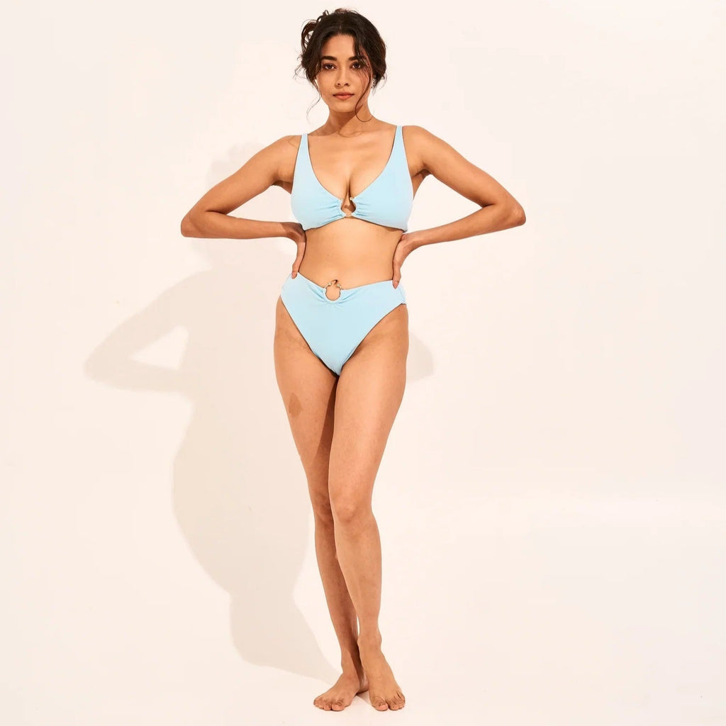 Woman wearing a light blue bikini on a plain background - The Beach Company